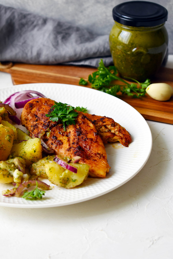 Grilled chicken breast with chimichurri sauce and potato salad