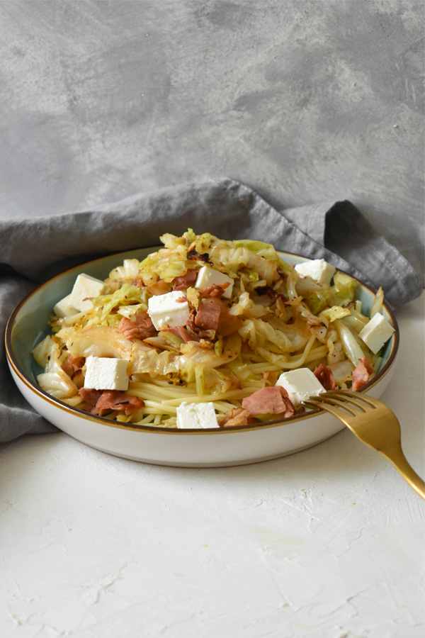 Spaghetti with roasted kale, ham, and feta cheese