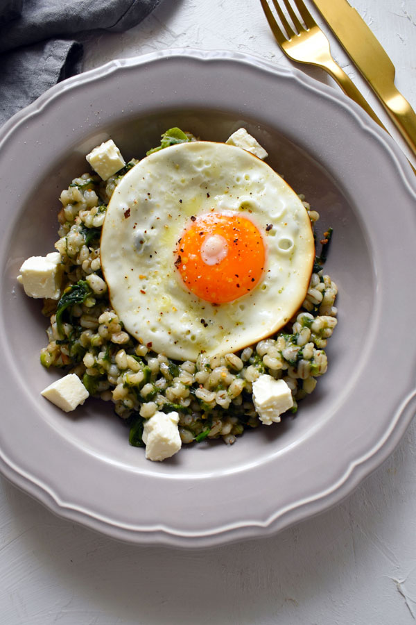 spinach and feta barley dish with fried eggs