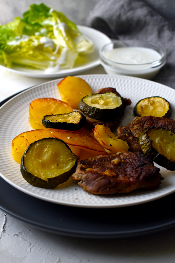 Garlic pork tenderloin baked with zucchini and potatoes