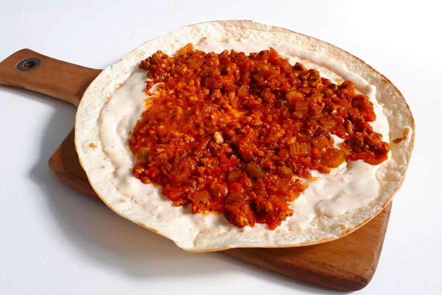 tortilla with bolognese ragout and cheese sauce