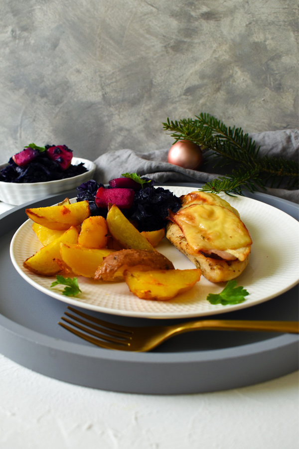 Roasted chicken breast with apples, cheese, and ham