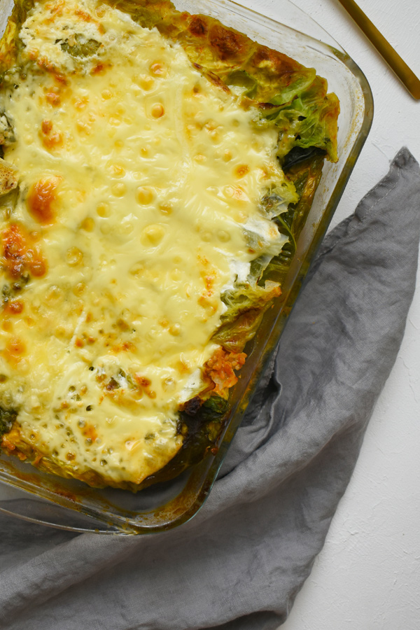 layered cabbage casserole with pork, rice, and Savoy cabbage, flavored with sweet paprika and topped with a layer of sour cream